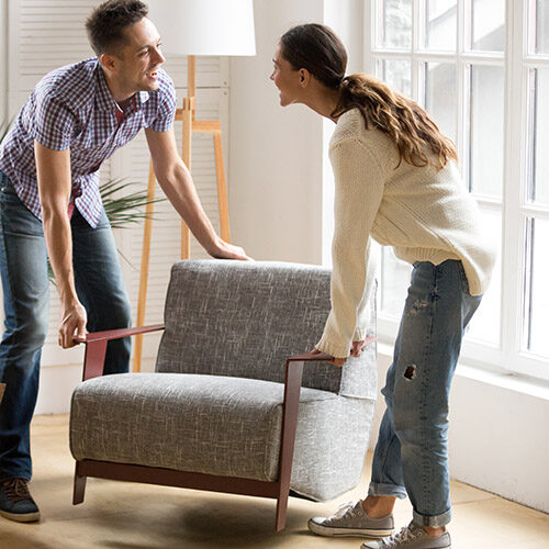 Couple carrying chair together | Howmar Carpet