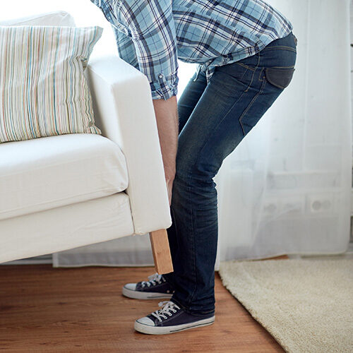 Boy lifting sofa | Howmar Carpet Inc